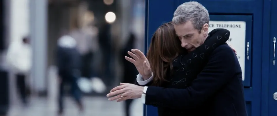 Clara Oswald and the Twelfth Doctor embracing